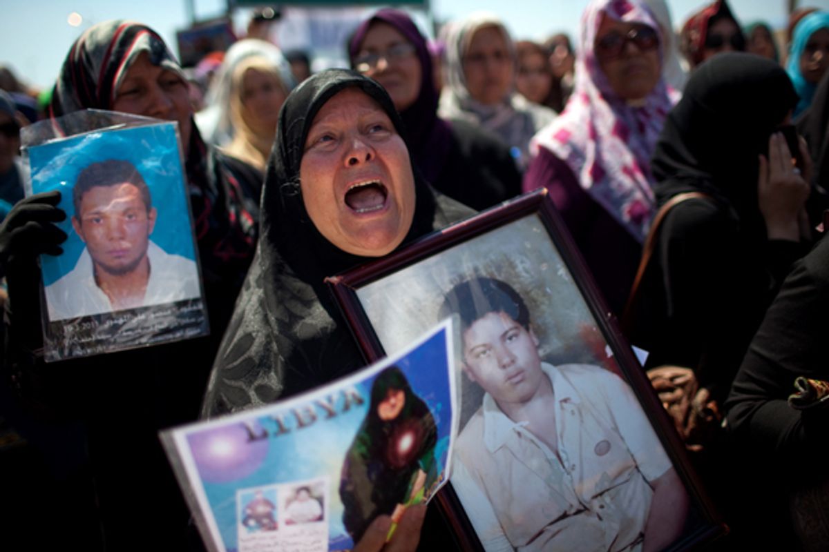 Galia Mohamed holds a portrait of her son, who was murdered in Bosalen prison by Moammar Gadhafi security forces in 1996. 