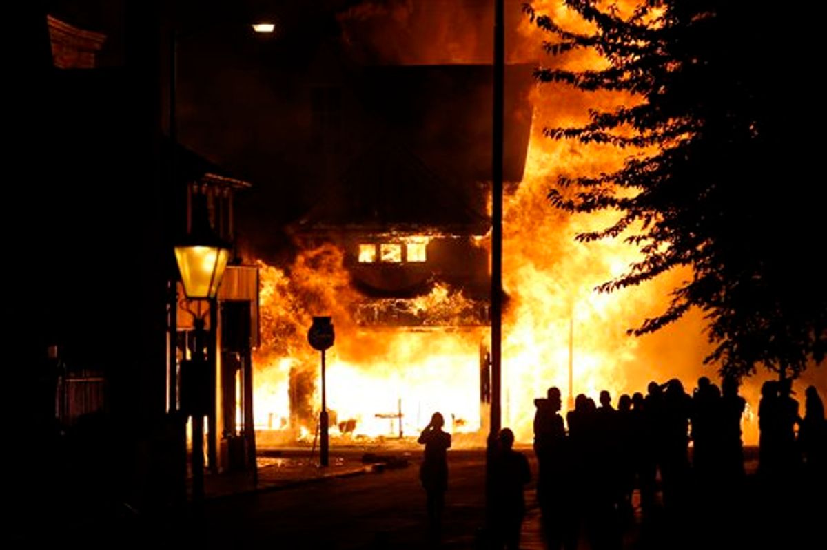 A shop is set on fire as rioters gathered in Croydon, south London, Monday, Aug. 8, 2011. Violence and looting spread across some of London's most impoverished neighborhoods on Monday, with youths setting fire to shops and vehicles, during a third day of rioting in the city that will host next summer's Olympic Games. (AP Photo/Sang Tan)  (AP)