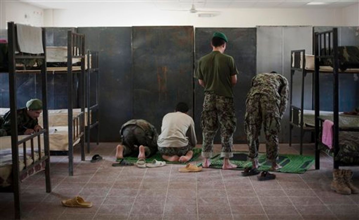 Afghan National Army soldiers pray inside their sleeping quarters at their barracks in Kunduz, northen Afghanistan, Sunday,Sept. 25, 2011. (AP Photo/Anja Niedringhaus)  (AP/Anja Niedringhaus)