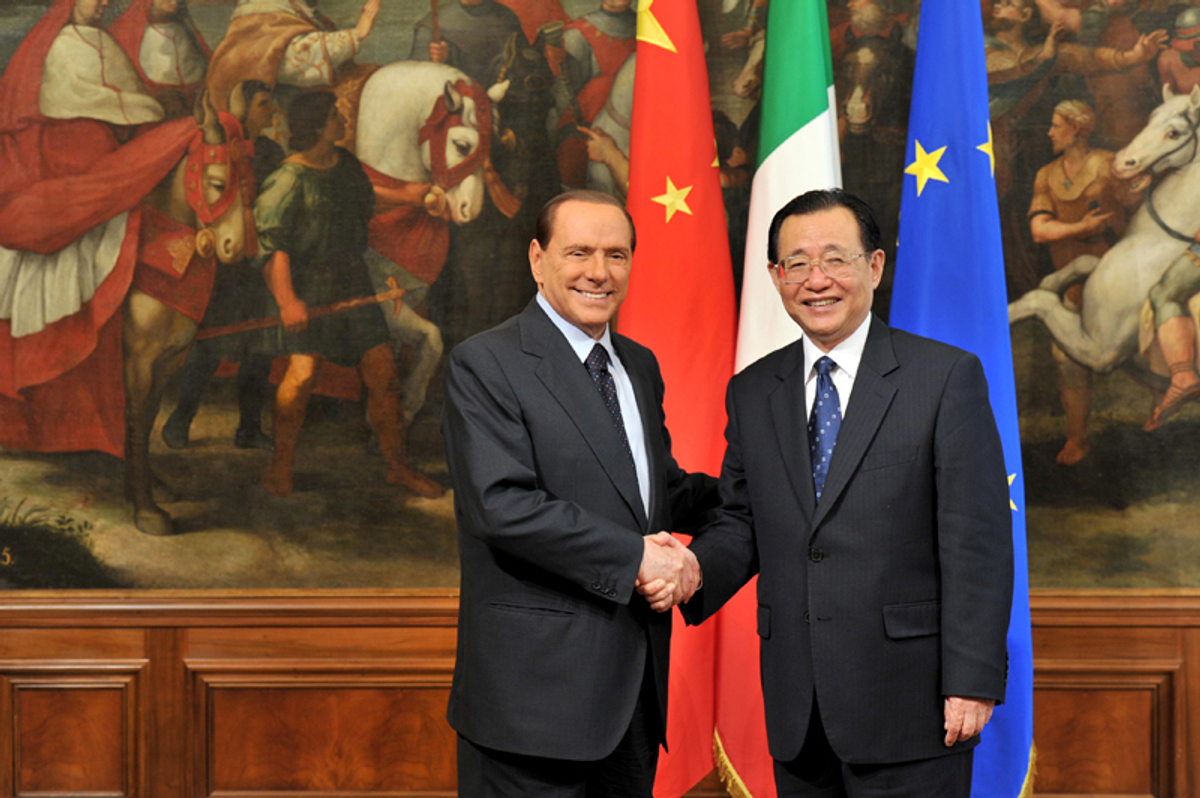 Italy's Prime Minister Silvio Berlusconi (L) welcomes Wang Gang, the vice-chairman of China's main government advisory body, during a meeting in Rome on September 14, 2011.