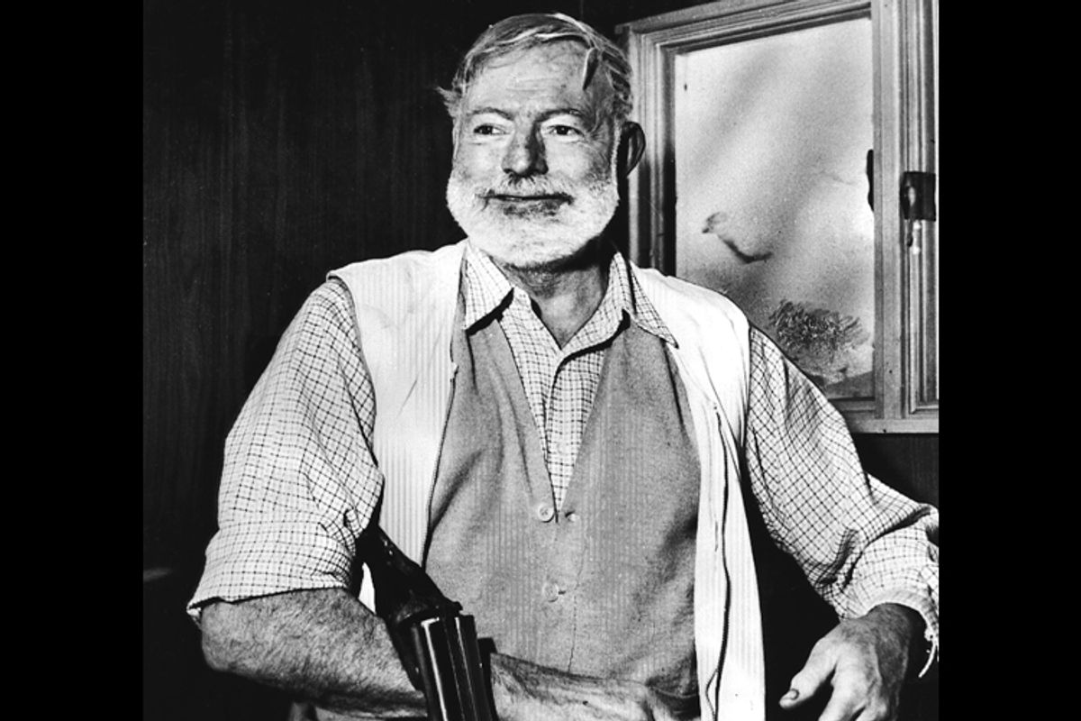 Ernest Hemingway, cradling a shotgun.  