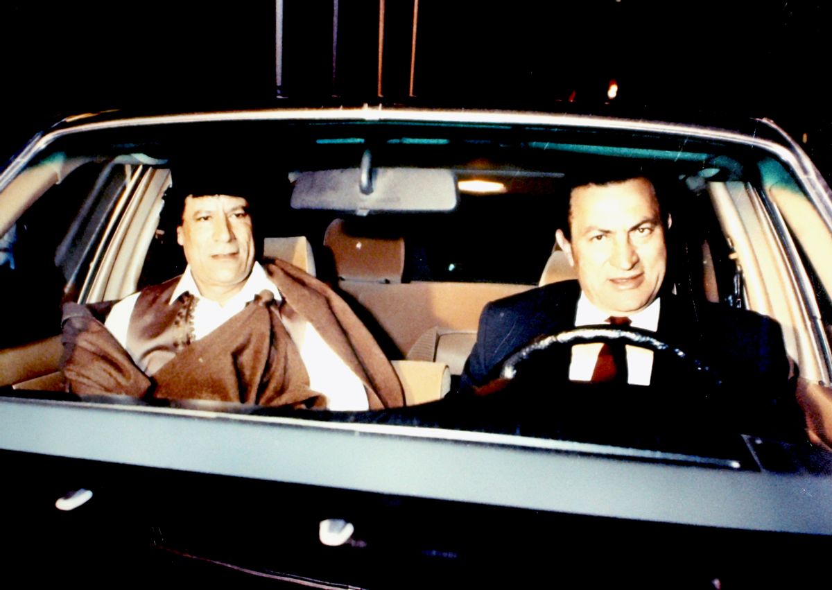FILE - In this August 1990 file photo, during an emergency Arab League summit, Libyan leader Moammar Gadhafi, left, is driven by Egyptian President Hosni Mubarak, in Tahrir Square in Cairo. As rebels swarmed into Tripoli, Libya, late Sunday, Aug. 21, 2011, and Gadhafi's son and one-time heir apparent Seif al-Islam was arrested, Gadhafi's rule was all but over, even though some loyalists continued to resist. (AP Photo/Farouk Ibrahim, File) (AP)