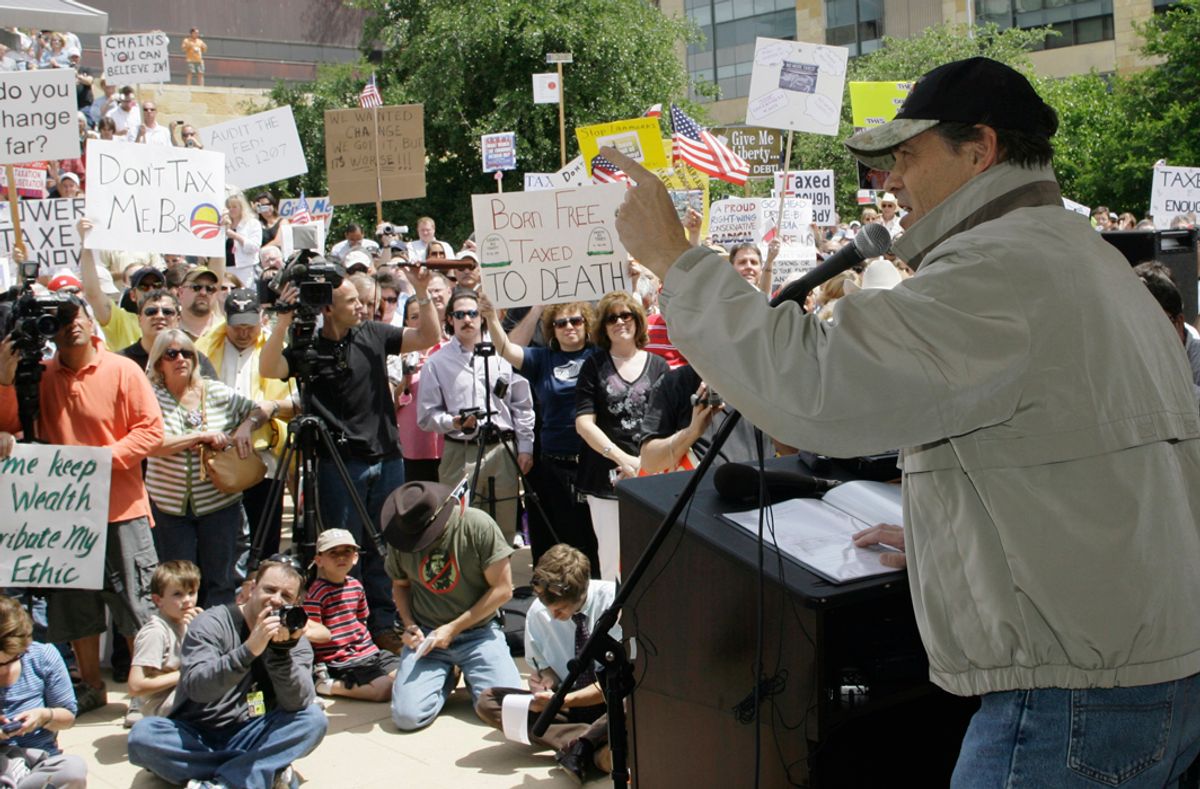 Gov. Rick Perry, right, speaks to the crowd during a "Don't Mess With Texas" tea party rally in Austin, Texas.