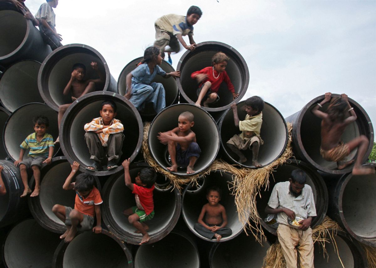 Children play in water pipes at a construction site on the banks of the Yamuna River in the northern Indian city of Allahabad July 26, 2010. REUTERS/Jitendra Prakash (INDIA - Tags: SOCIETY IMAGES OF THE DAY) (Â© Jitendra Prakash / Reuters)