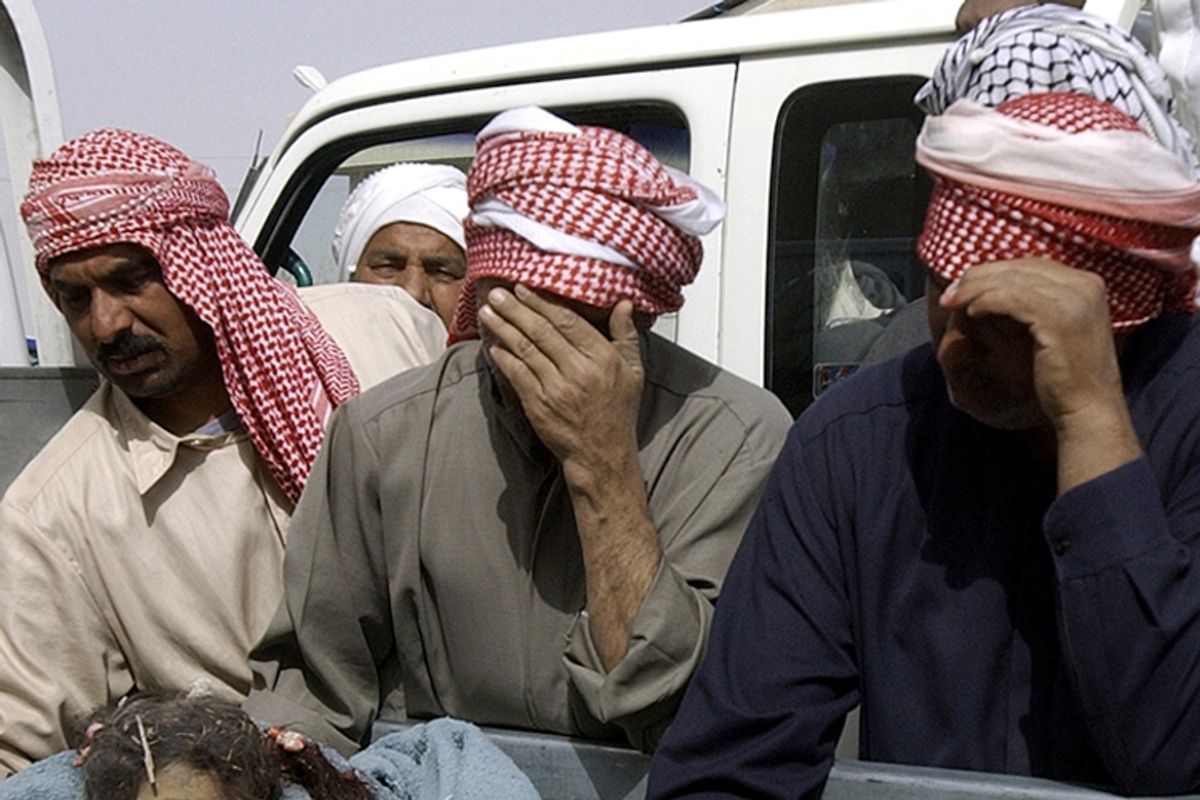 Relatives mourn near the bodies of children, reportedly killed in a March 15, 2006 U.S. raid in the village of Ishaqi.