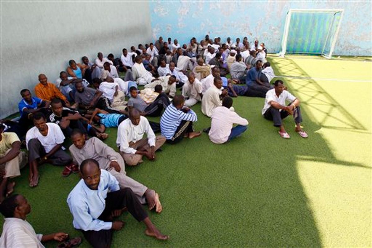 Men suspected of being mercenaries for Moammar Gadhafi, are held in a district sports center next to the medina, set up as provisory jail in Tripoli, Libya, Tuesday, Aug. 30, 2011.  Libyan rebels are demanding that Algeria return Moammar Gadhafi's wife and three of his children for trial after they fled, raising tensions between the neighboring countries. Algeria's decision to host members of the Gadhafi clan is an "aggressive act against the Libyan people's wish," said Mahmoud Shammam, information minister in the rebels' interim government.(AP Photo/Francois Mori) (AP)