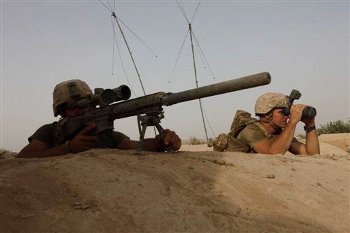Members of U.S. Marine Scout-Sniper team look for a Taliban position in a nearby tree-line, during an exchange of fire with Taliban militants, in Helmand province, southern Afghanistan, Saturday, Aug. 27, 2011. (AP Photo/Brennan Linsley) (AP)