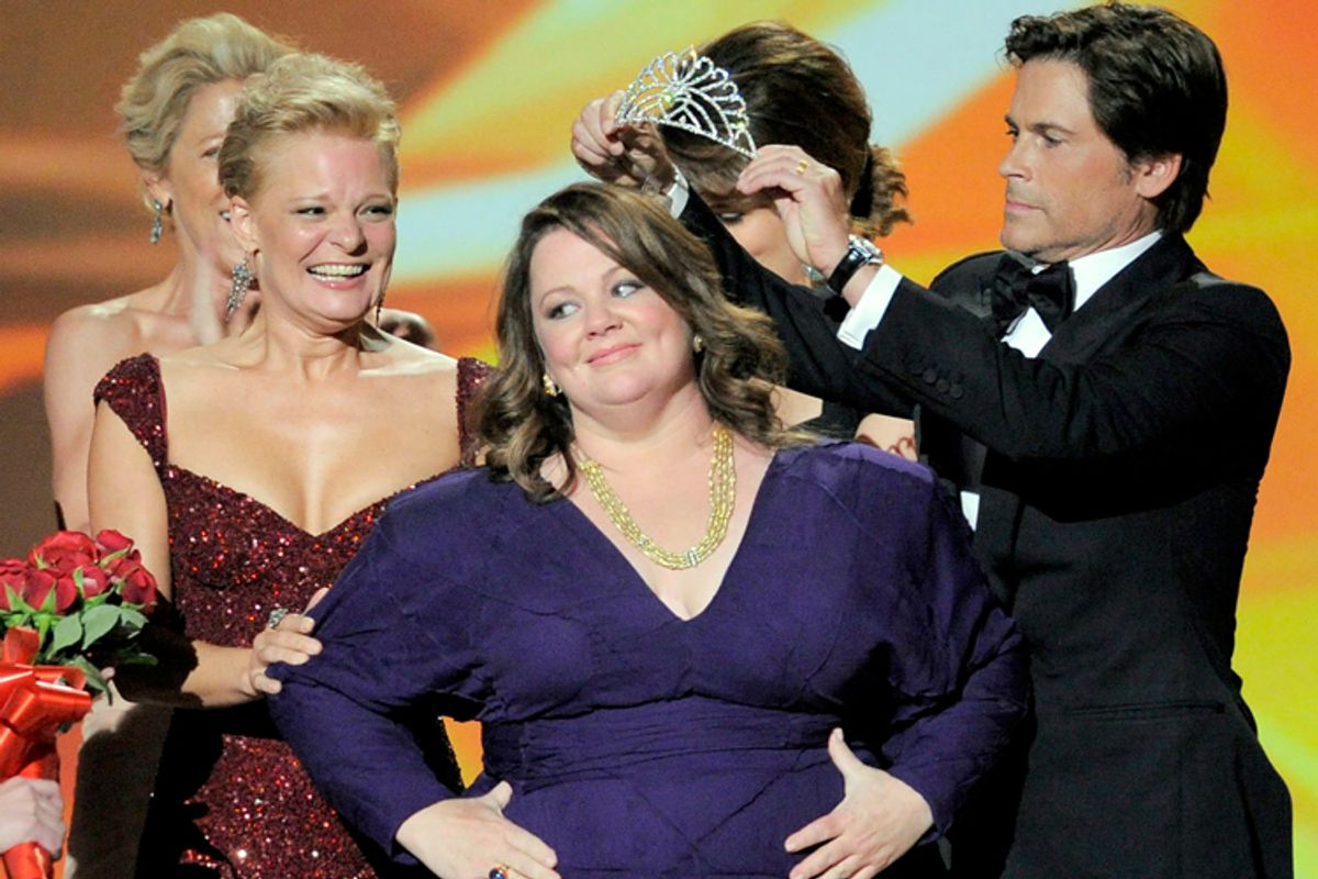 Rob Lowe, crowns Melissa McCarthy as Sofia Vergara, second right, gives her the award for outstanding lead actress in a comedy series for "Mike and Molly" at the 63rd Primetime Emmy Awards on Sunday, Sept. 18, 2011 in Los Angeles.
