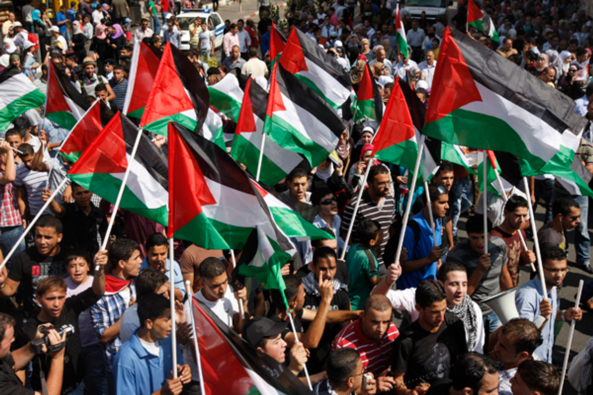 People in the West Bank wave flags in support of the Palestinian bid for statehood recognition in the United Nations, Wednesday, Sept. 21, 2011