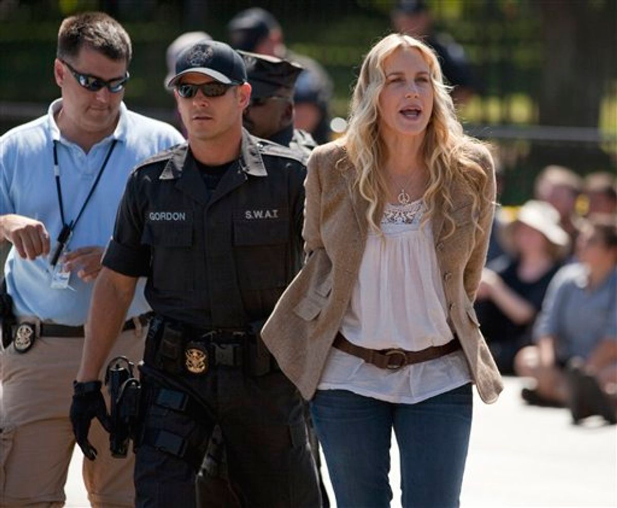 Actress Daryl Hannah is arrested by U.S. Park Police in front of the White House in Washington, Tuesday, Aug. 30, 2011, during a protest against the Keystone oil pipeline.  (AP Photo/Evan Vucci) (AP)