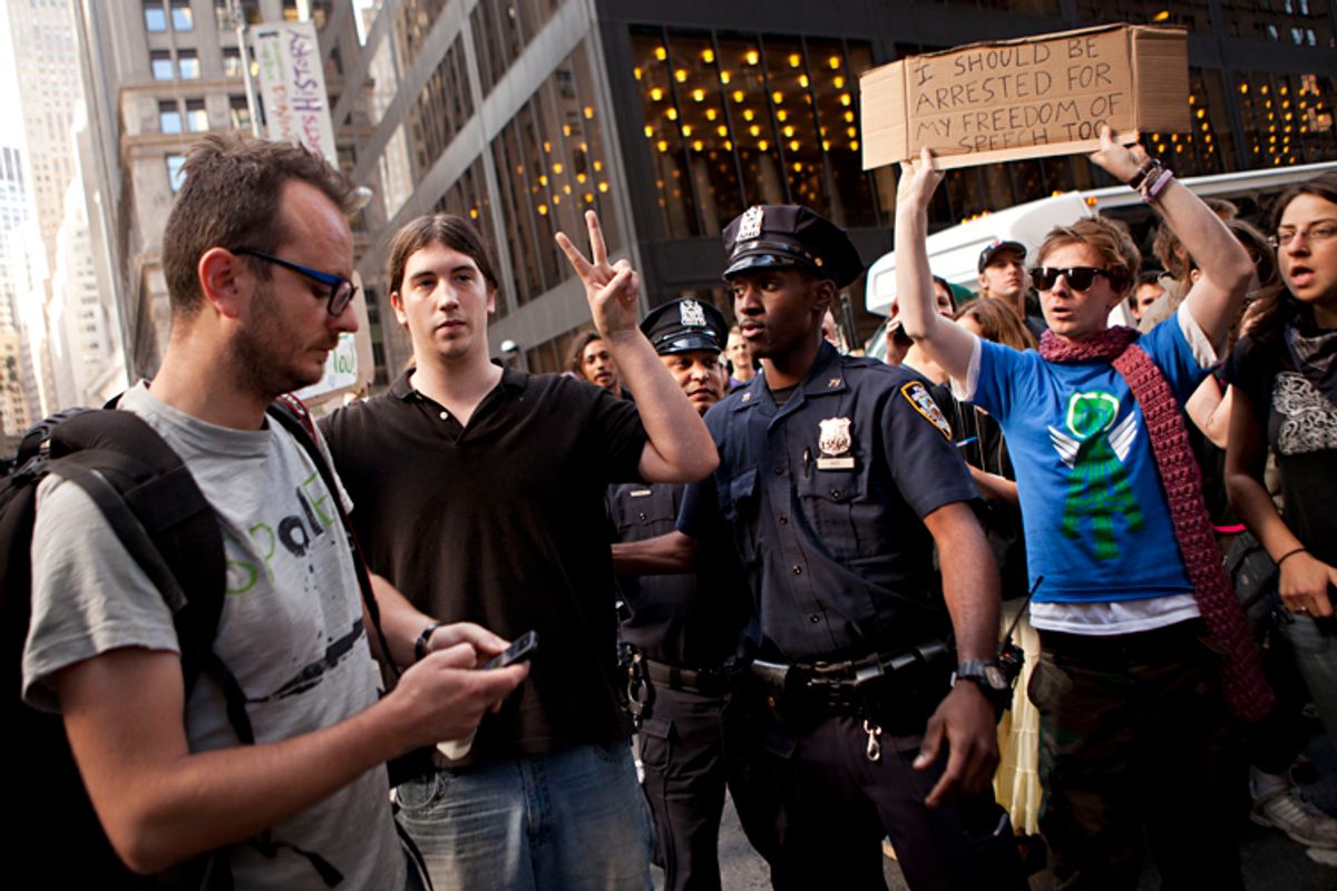 Laurentiu Garofeanu, left, and a second protestor participating in the "Occupy Wall Street"  protests, are arrested by the New York City police officers outside Zuccotti Park in New York, on Monday, Oct. 10, 2011.      (AP/Andrew Burton)