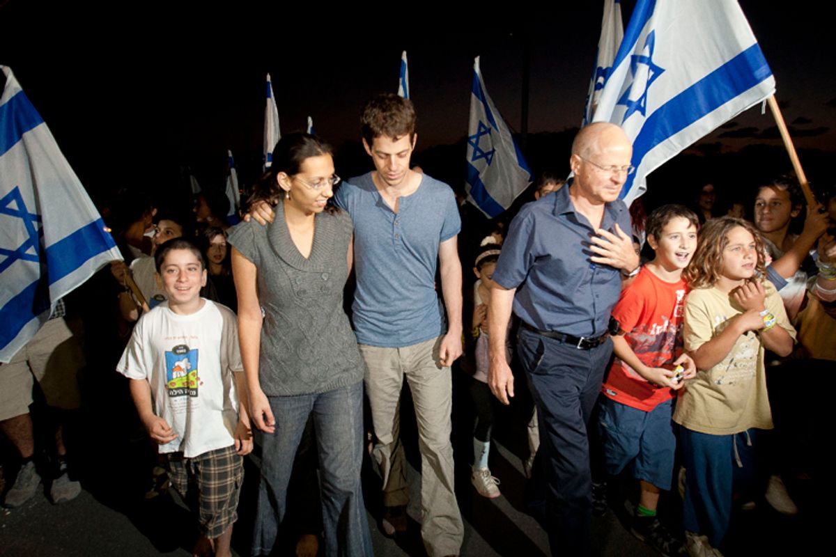 Noam Schalit, right, Yoel Schalit and Yaara Winkler, father and brother of captured Israeli soldier Gilad Schalit walk with family and friends to their home in Mitzpe Hila, northern Israel, Wednesday, Oct. 12, 2011.    (AP)