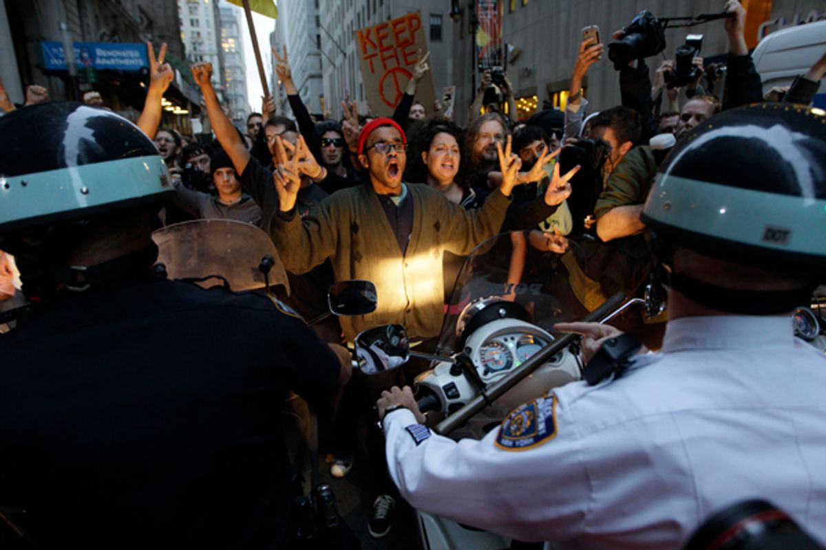 Demonstrator affiliated with the Occupy Wall Street protests confront New York City police officers as they march on the street in the Wall St. area, Friday, Oct. 14, 2011 in New York.  (AP/Mary Altaffer)