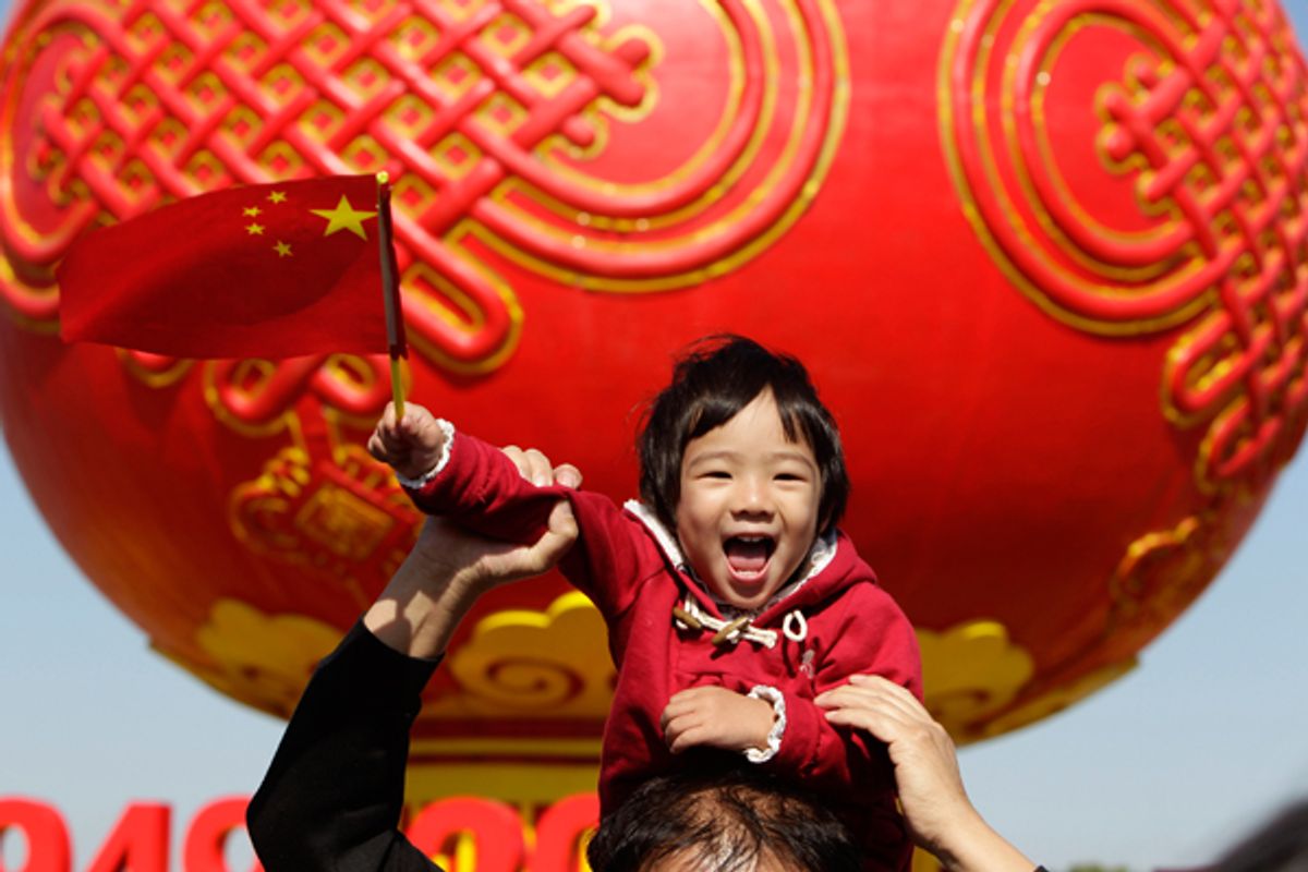  A child poses in front of a giant red lantern on display at Beijing's Tiananmen Square on China's National Day.           (Reuters/Jason Lee)