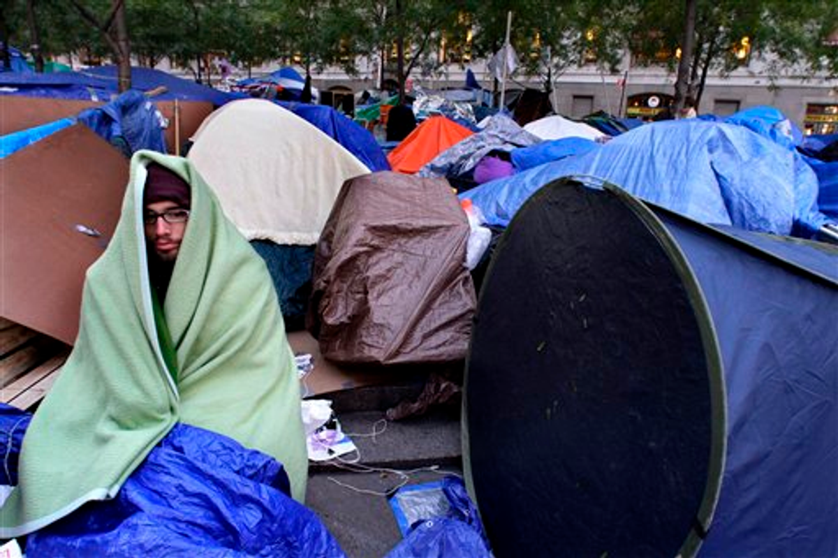 A protester is wrapped in a blanket to stay warm at the Occupy Wall Street protest at Zuccotti Park on Friday, Oct. 28, 2011 (AP Photo/Bebeto Matthews)