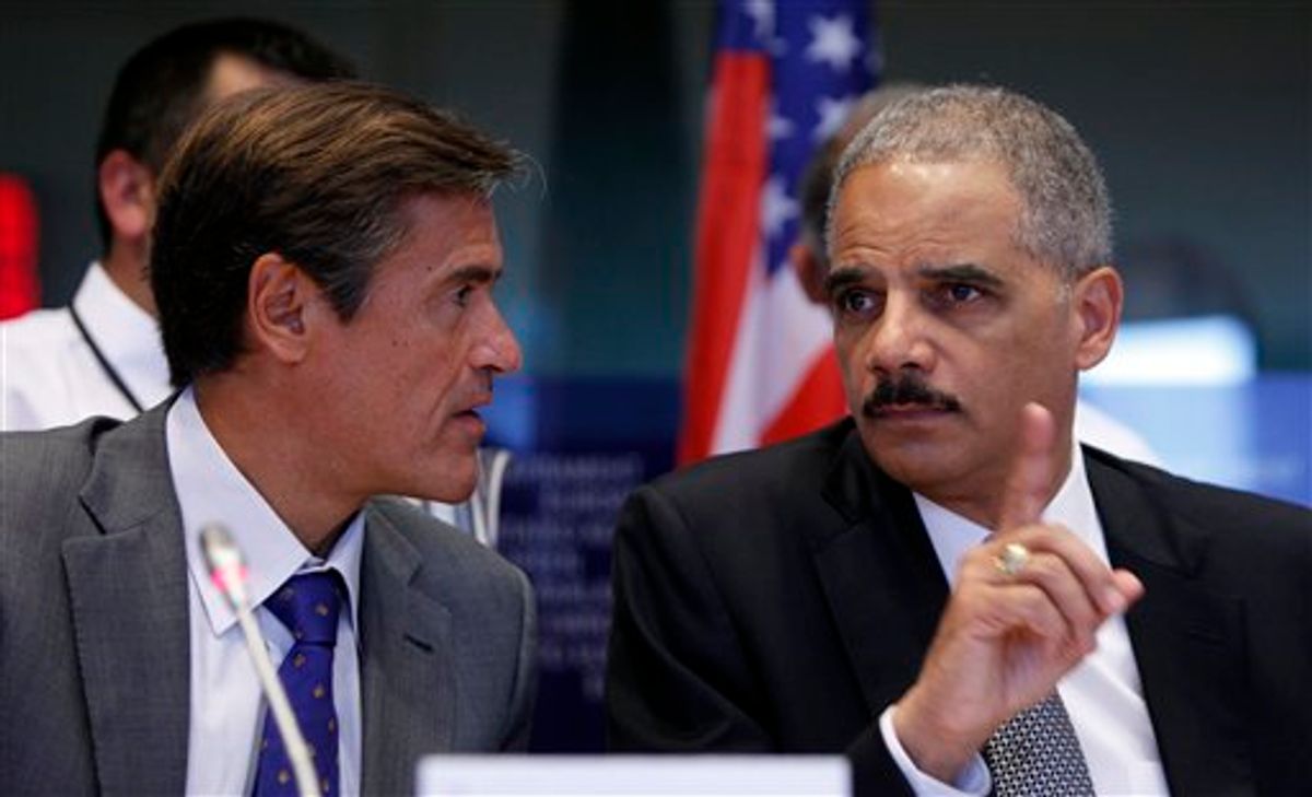 Spanish MEP Juan Fernandez Aguilar, left, looks on as United States Attorney General Eric Holder, right, speaks during a session at the European Parliament in Brussels on Tuesday, Sept. 20, 2011.          (AP/Virginia Mayo)