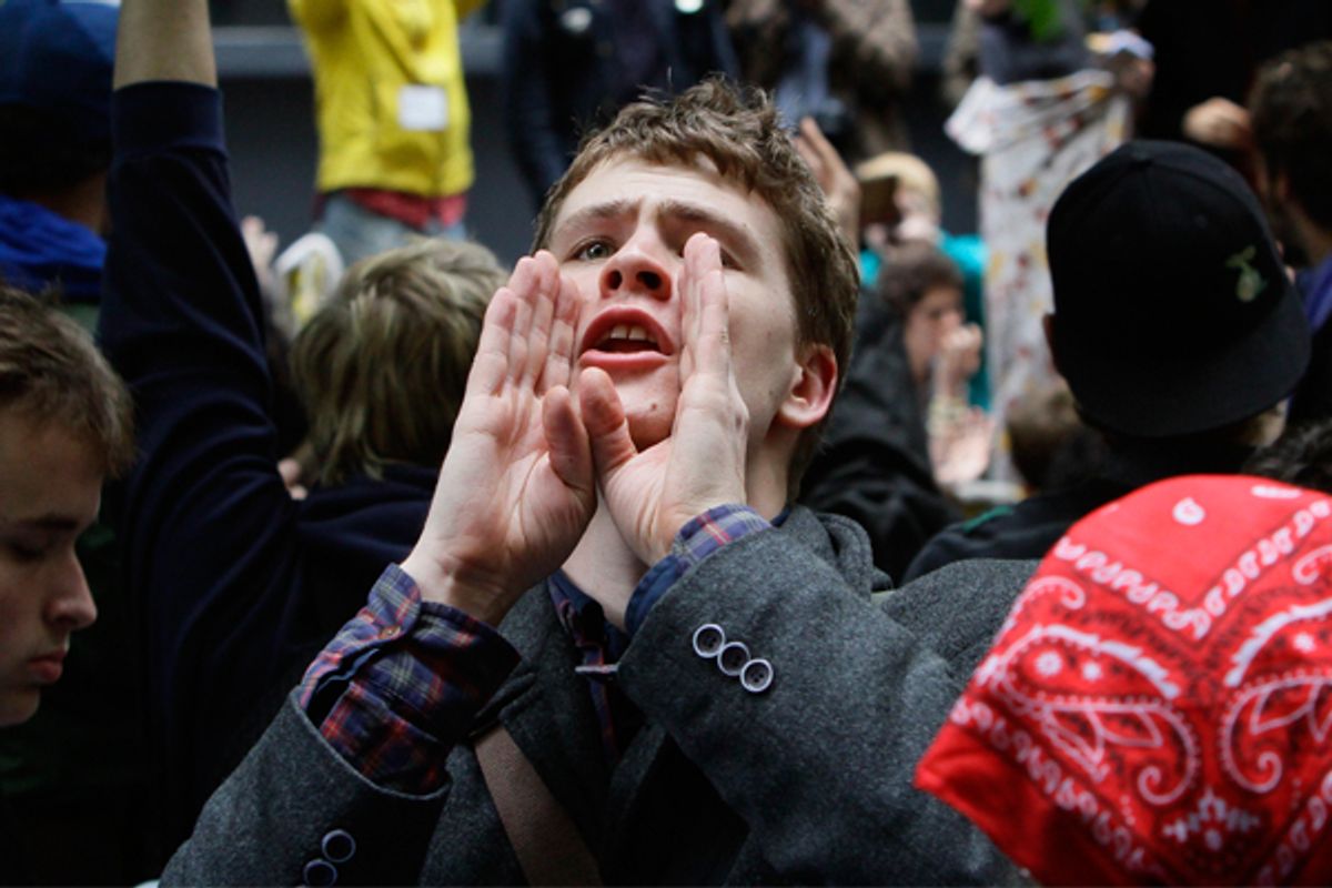 A protestor takes on the role of a human microphone, relaying information throughout Zuccotti Park's Occupy Wall Street encampment.   (AP/Bebeto Matthews)
