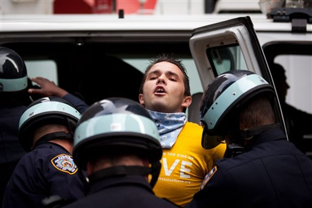 Occupy Wall Street protestor Lincoln Statler is arrested along with several others in the financial district's Zucotti park, Monday, Oct. 3, 2011.   (AP Photo/John Minchillo)