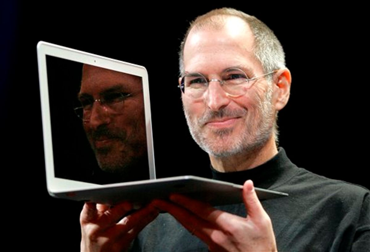 Apple CEO Steve Jobs holds up the new MacBook Air after giving the keynote address at the Apple MacWorld Conference in San Francisco in 2008.     (AP Photo/Jeff Chiu, File)