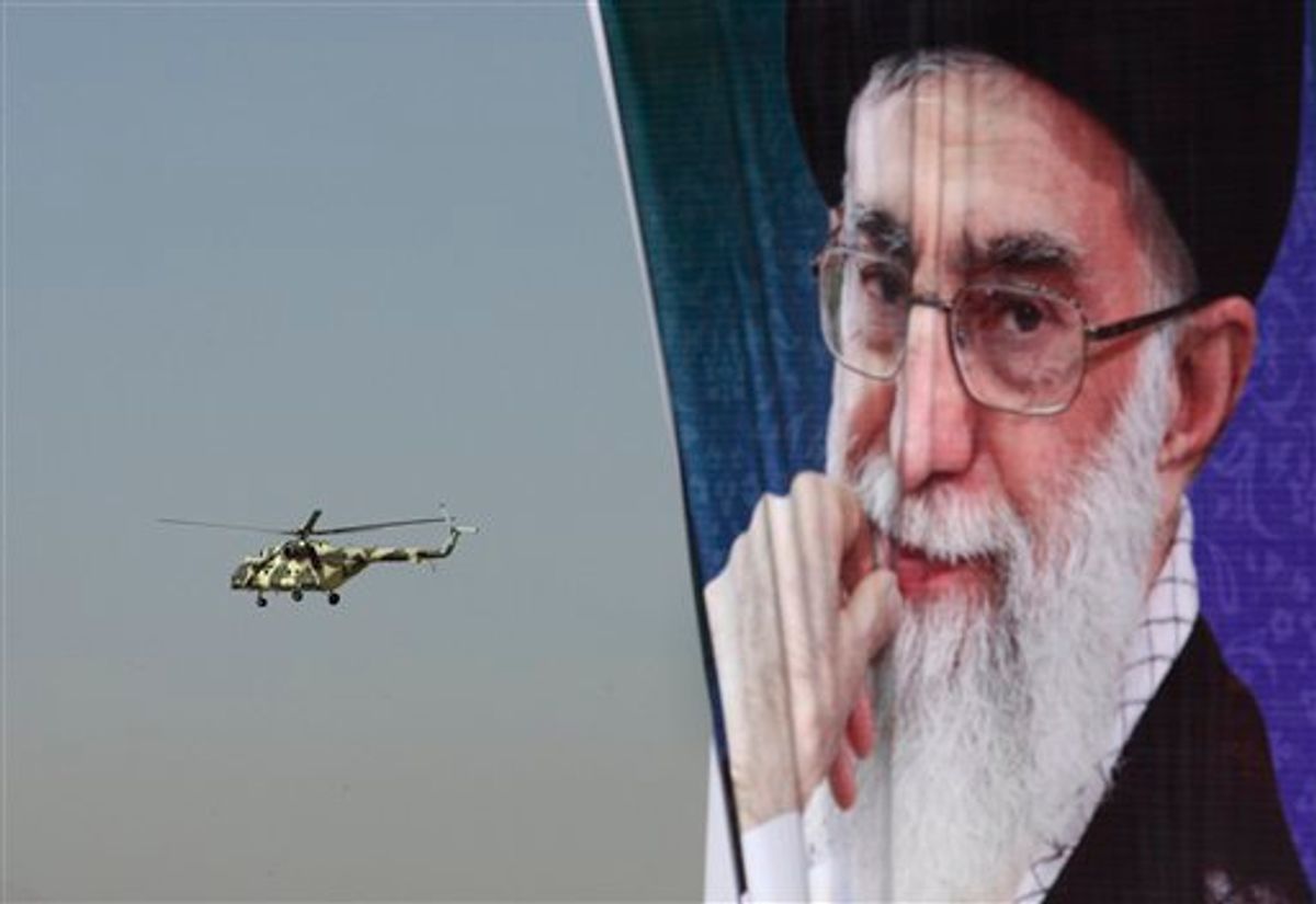 A police helicopter flies behind a poster of Iranian supreme leader Ayatollah Ali Khamenei during an exercise commemorating "Police Week", in downtown Tehran, Iran, Friday, Oct. 7, 2011.  (AP Photo/Vahid Salemi)
