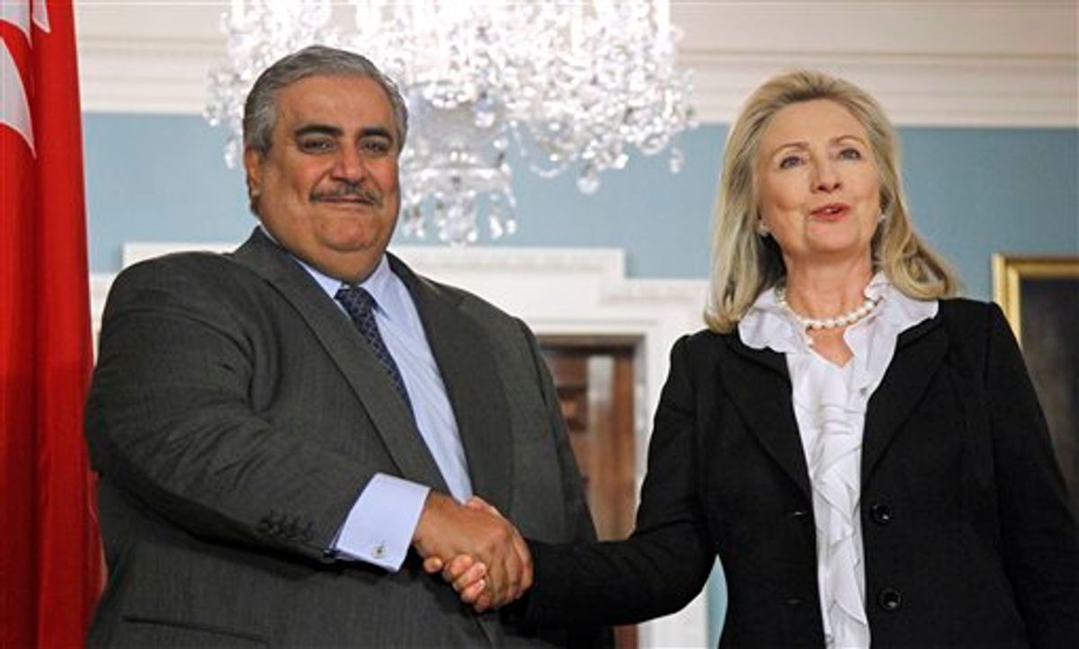 Secretary of State Hillary Rodham Clinton shakes hands with Bahrain's Foreign Minister Shaikh Khalid bin Ahmed al-Khalifa after delivering a statement, Wednesday, Oct. 26, 2011, at the State Department in Washington.     (AP Photo/Haraz N. Ghanbari)