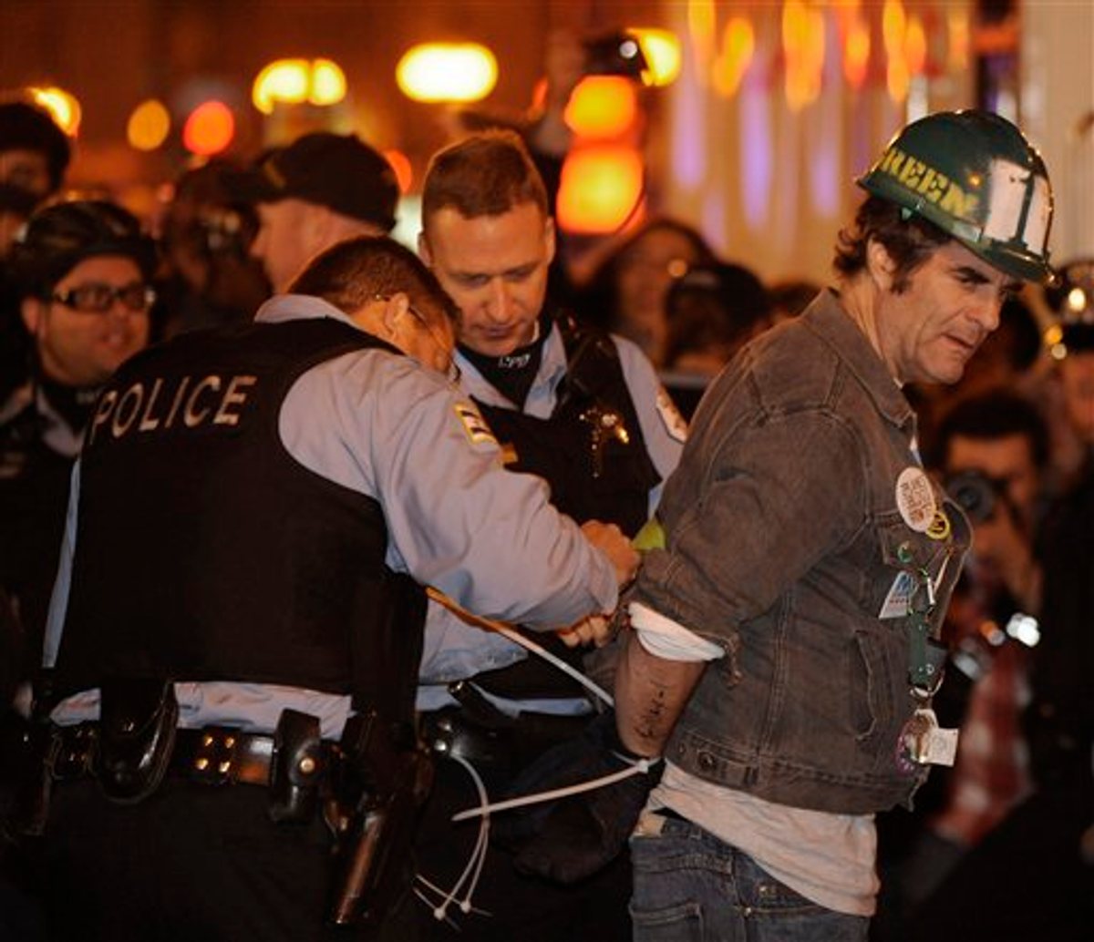 A protester gets arrested during an Occupy Chicago march and protest in Grant Park in Chicago, Sunday, Oct. 23, 2011    (AP Photo/Paul Beaty)