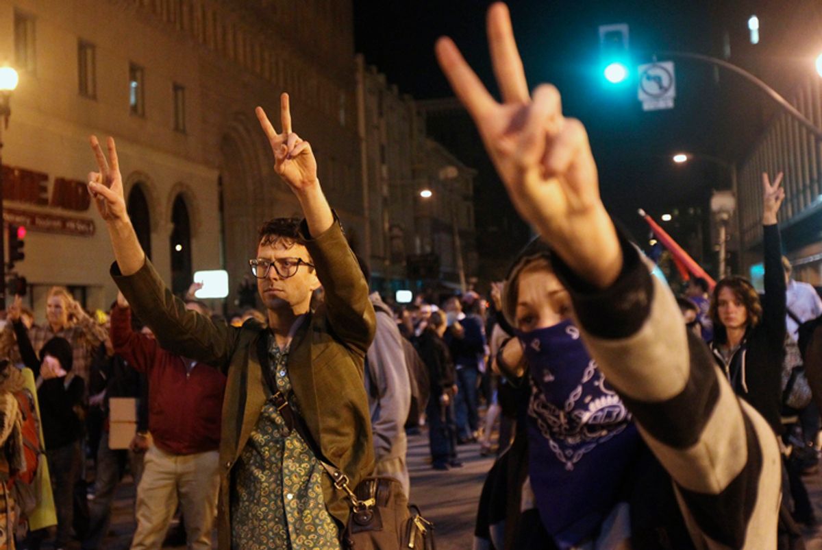 A group of "Occupy Wall Street" demonstrators flashing peace signs in Oakland    (Stephen Lam / Reuters)