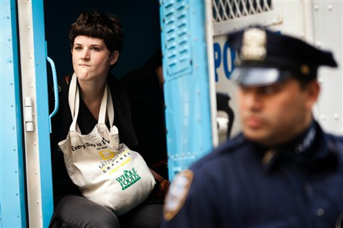  An Occupy Wall Street protester is arrested for allegedly trespassing on Citibank property near Washington Square Park, Saturday, Oct. 15, 2011, in New York        (AP Photo/John Minchillo)