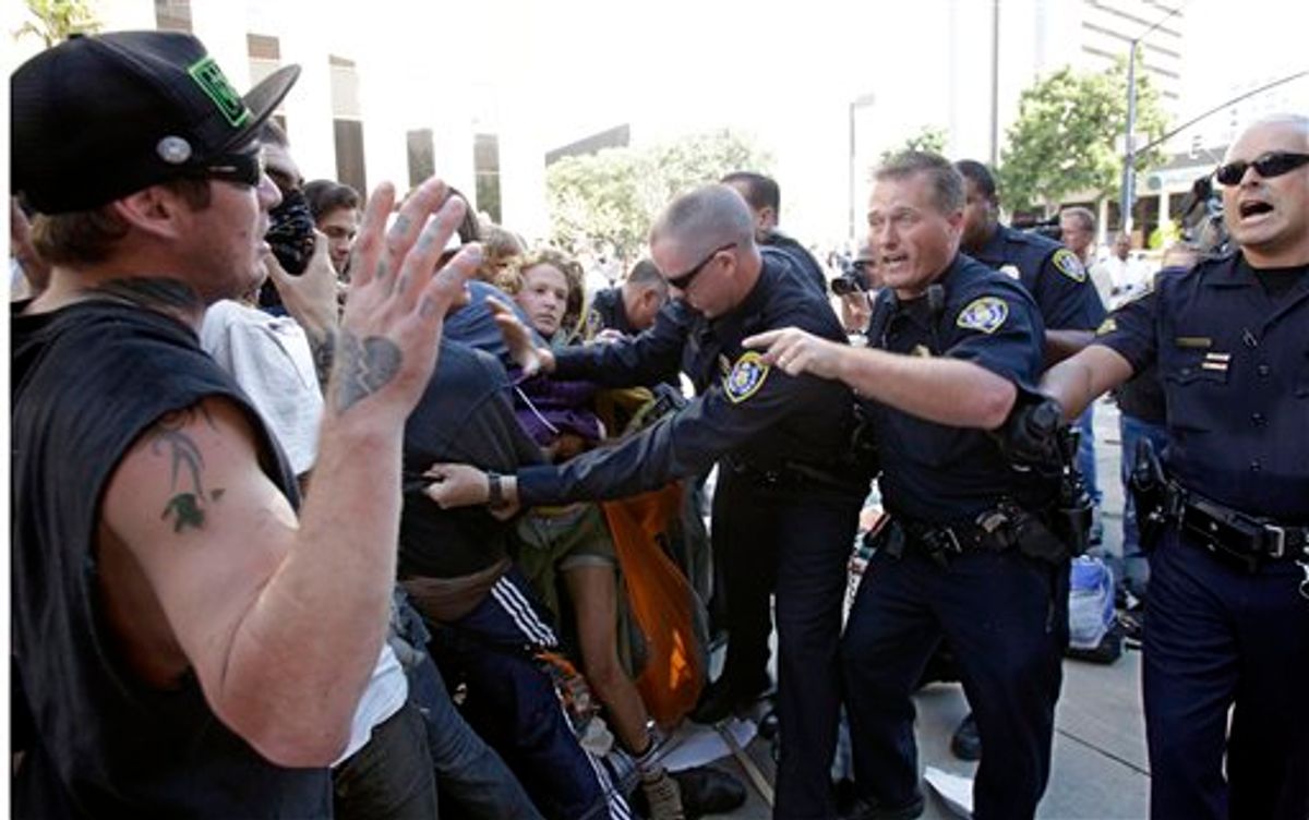 San Diego Police clash with demonstrators at the Civic Center Plaza Friday, Oct. 14, 2011 in San Diego.     (AP/Lenny Ignelzi)