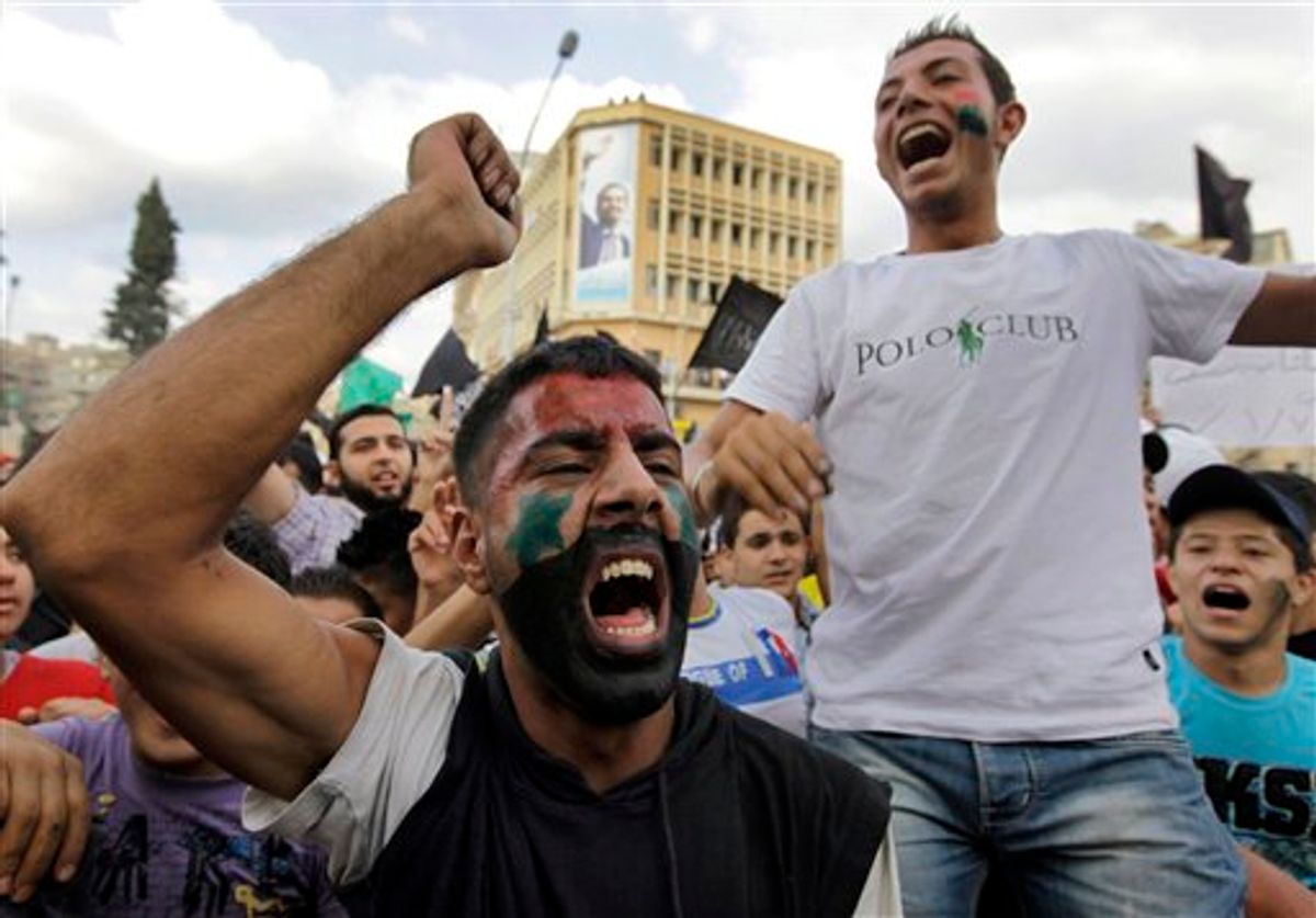 Anti-regime protesters shout slogans against Syrian President Bashar Assad, during a protest after Friday prayers in the northern city of Tripoli, Lebanon, on Friday Oct, 7, 2011 in a show of support for Syrians protesting against Syrian President Bashar Assad. ()   (AP/Bilal Hussein)