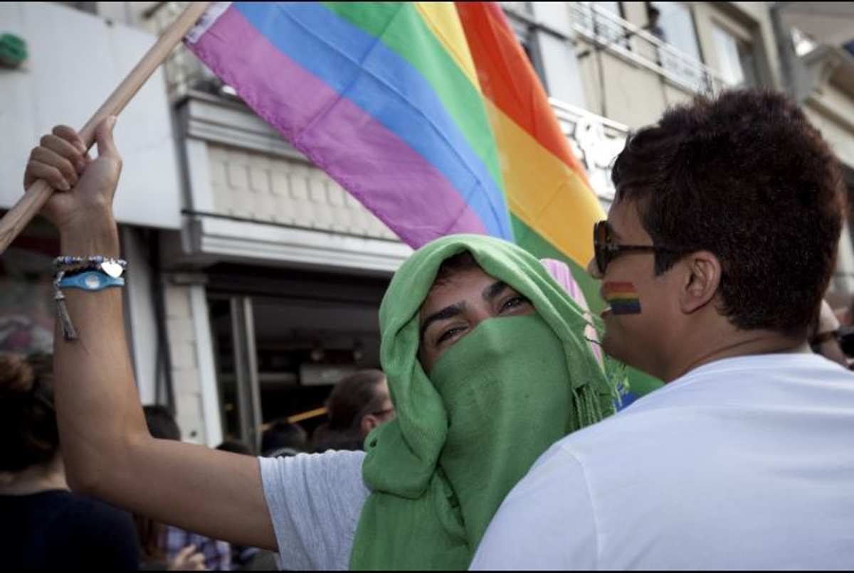 Holding a rainbow flag and dressed in hijab, an LGBT supporter makes a political statement at the Gay Pride March in Istanbul on June 19, 2011        (Jodi Hilton/GlobalPost)
