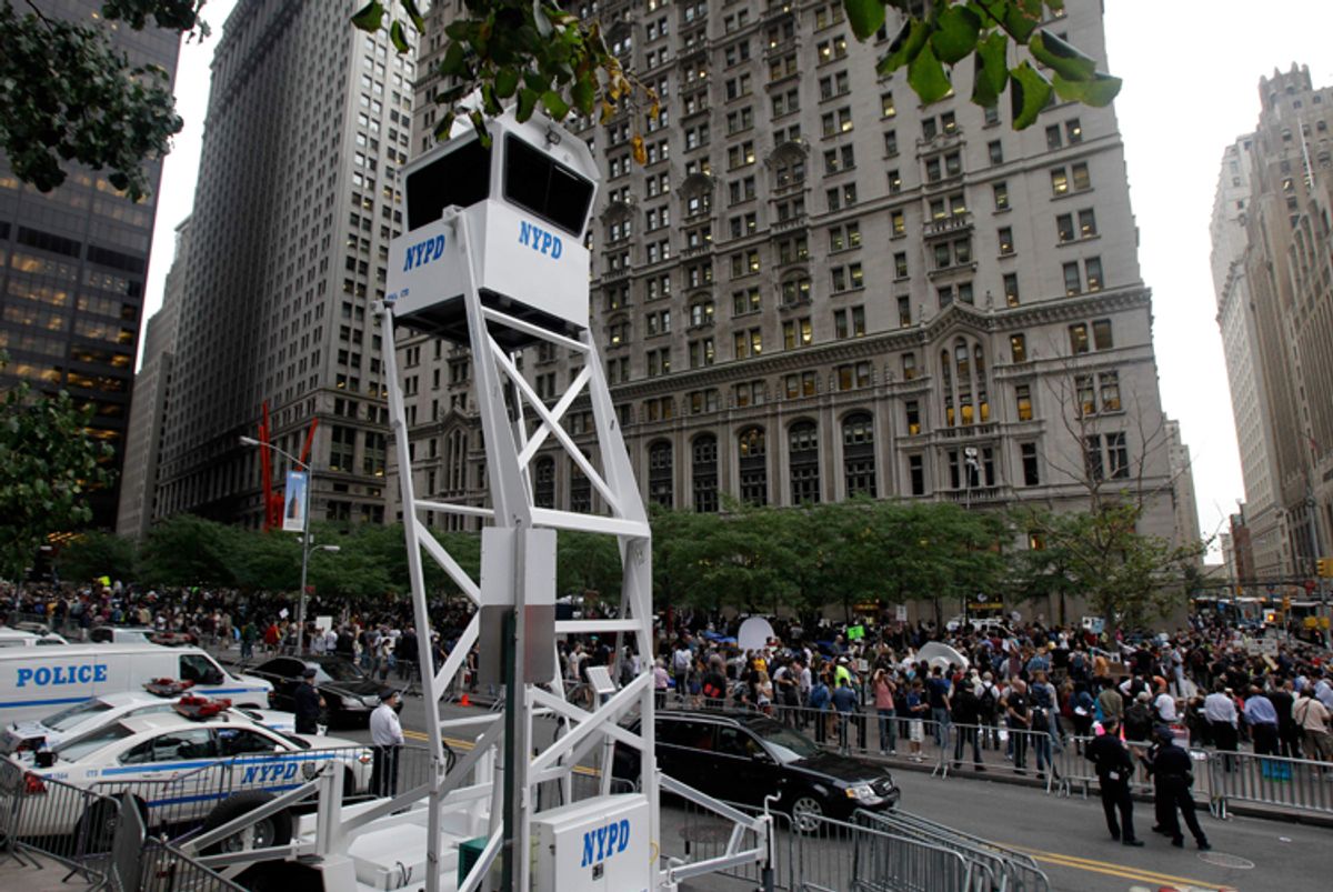 A New York Police Department guard tower looms over the Occupy Wall Street protest encampment at Zuccotti Park in New York       (Kathy Willens/AP)