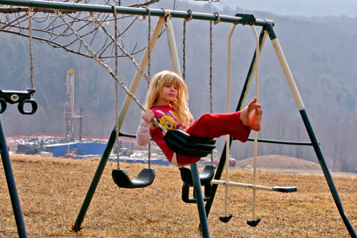 Rachel Farnelli rides on her backyard swing that overlooks the Gesford #3 natural gas well in Dimock, Pennsylvania, in this March 7, 2009 file photo.      (Tim Shaffer / Reuters)
