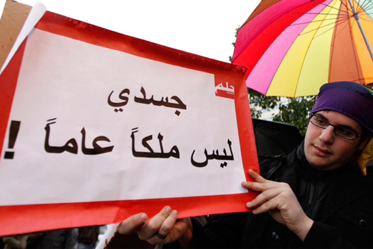 A protester carries a banner that reads in Arabic, "My body is not public property" during a sit-in for gays and lesbians in Beirut. (AP/Hussein Malla)