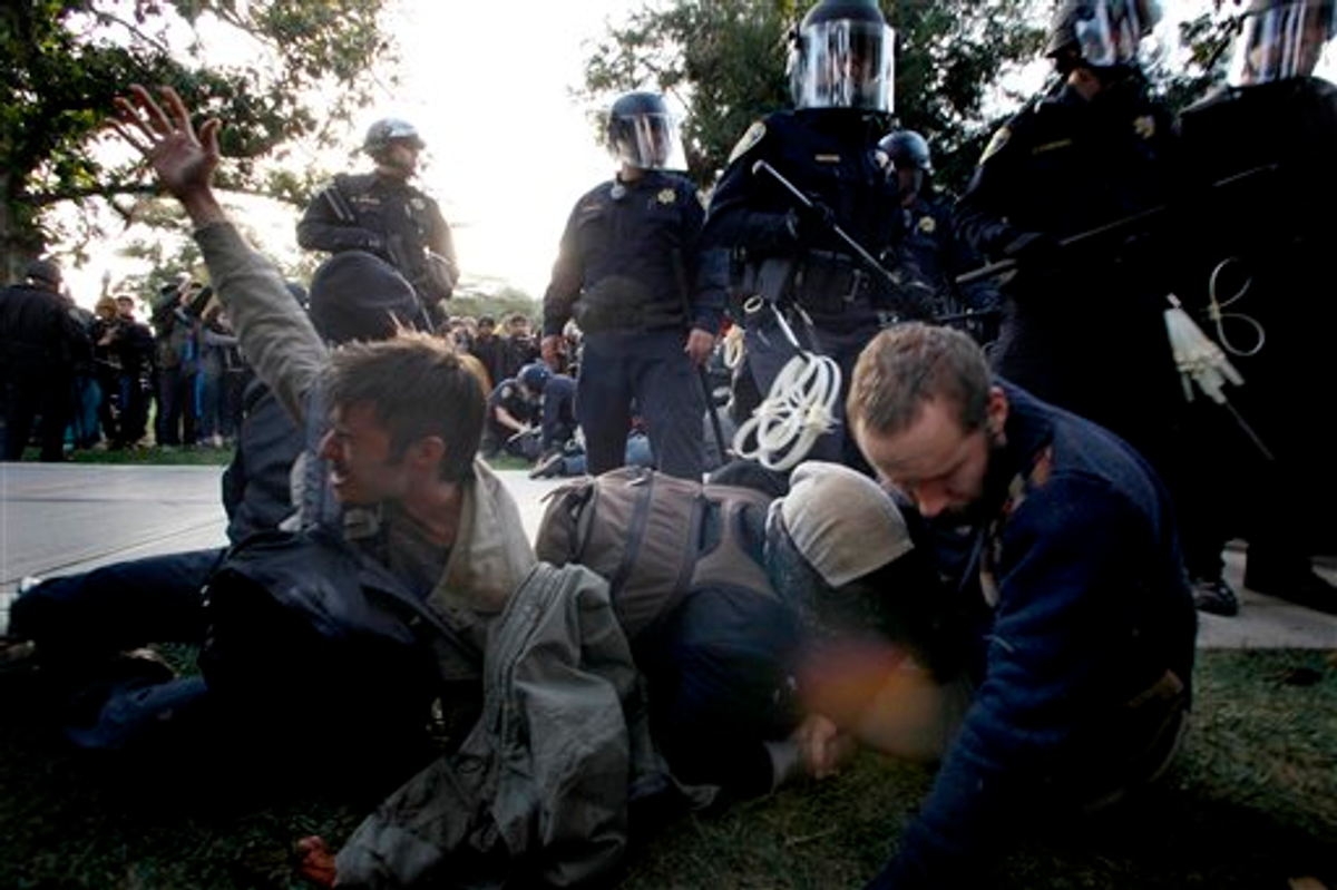 Protesters at University of California, Davis react after being pepper sprayed by police on Friday, November 18, 2011     (AP Photo/The Enterprise, Wayne Tilcock)