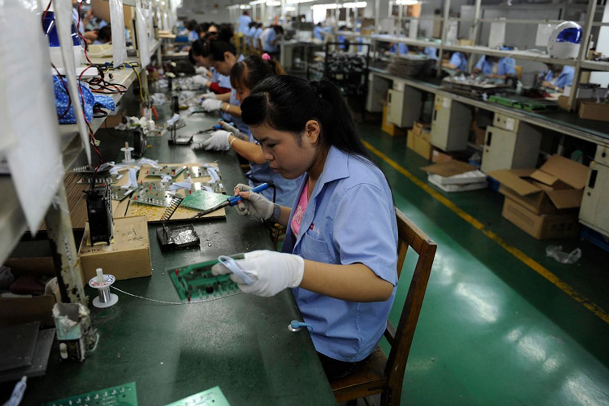 An employee works on circuit boards at an electronic component factory in Hefei, Anhui province, China.         (Jianan Yu / Reuters)