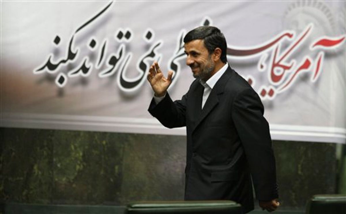 Iranian President Mahmoud Ahmadinejad, waves, as he arrives to attend an open session of parliament in Tehran, Iran, Tuesday, Nov. 1, 2011.    (AP/Vahid Salemi)