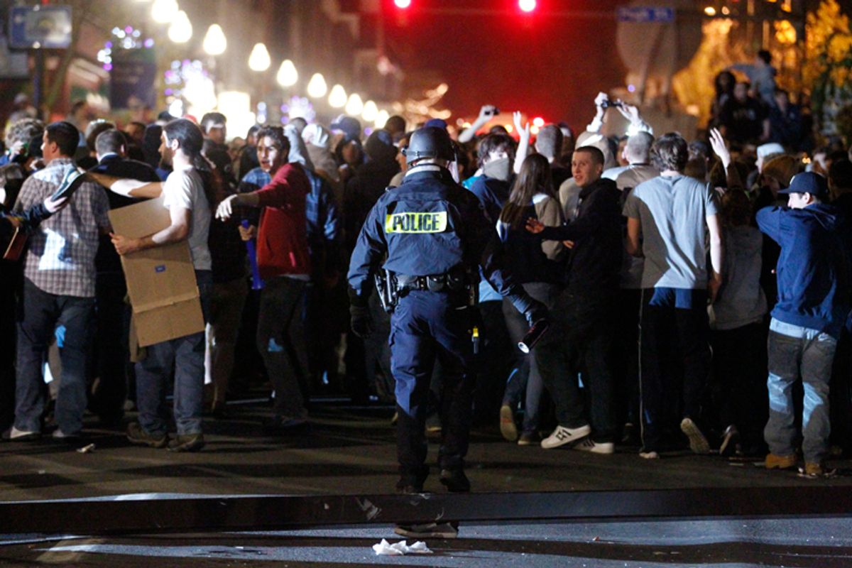Police hold back students after they reacted off campus Nov. 10, 2011, in State College, Pa., to firing of football coach Joe Paterno.     (AP/Matt Rourke)