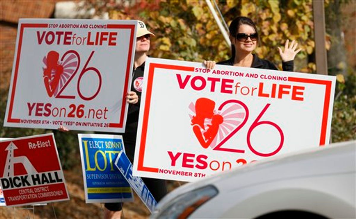 Christi Chandler, left, and Stacy Hawsey, both of Madison and supporters of the Personhood Amendment promote their initiative as they waver signs at drivers in the midst of last minute campaigning Tuesday, Nov. 8, 2011 in Madison, Miss. (AP Photo/Rogelio V. Solis)    (AP)