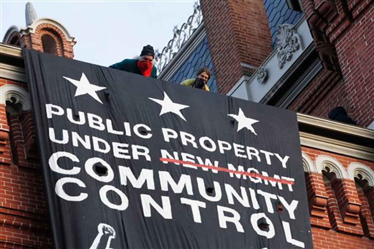 A group of protesters inspired by Occupy D.C. protest hang a banner on Franklin School building, in Washington, Saturday, Nov., 19, 2011   (AP Photo/Pablo Martinez Monsivais)