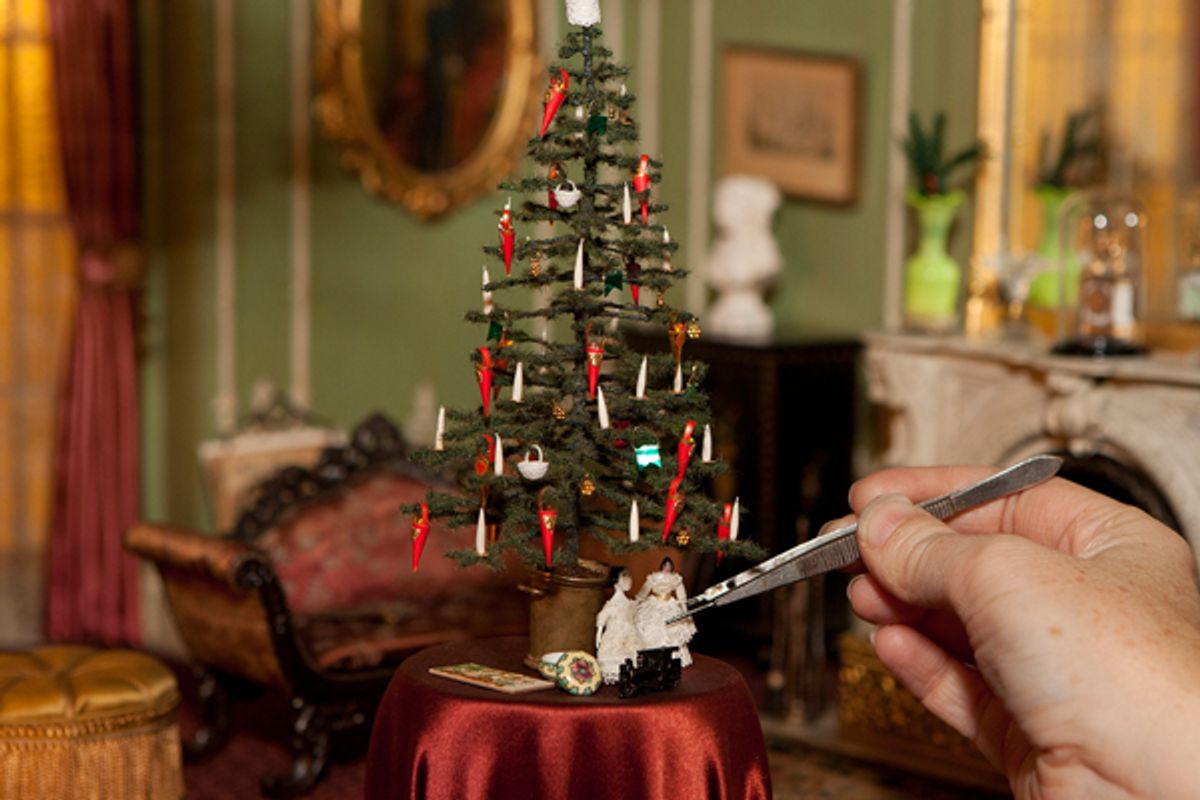 Thorne Rooms caretaker Lindsey Mican Morgan adjusts tiny decorations in a miniature Victorian English drawing room. (The Art Institute of Chicago)
