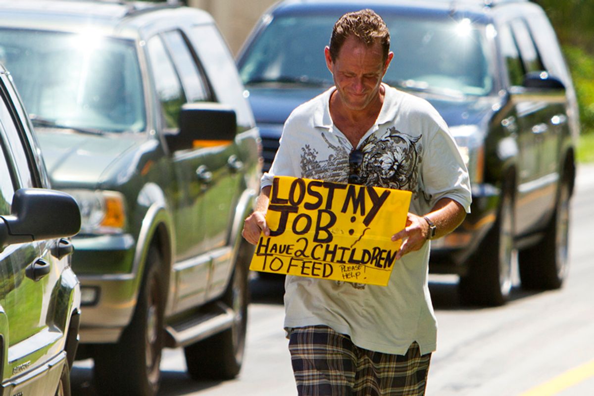 A man who did not wish to be identified, who lost his job two months ago after being hurt on the job, works to collect money for his family on a Miami street corner              (AP/J Pat Carter)