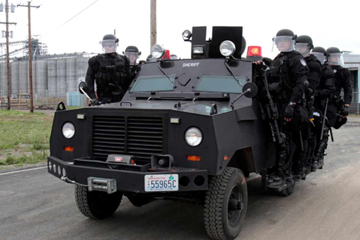 Police in riot gear move to a location at the port facilities in Longview, Wash., Wednesday, Sept. 21, 2011.      (AP/Don Ryan)