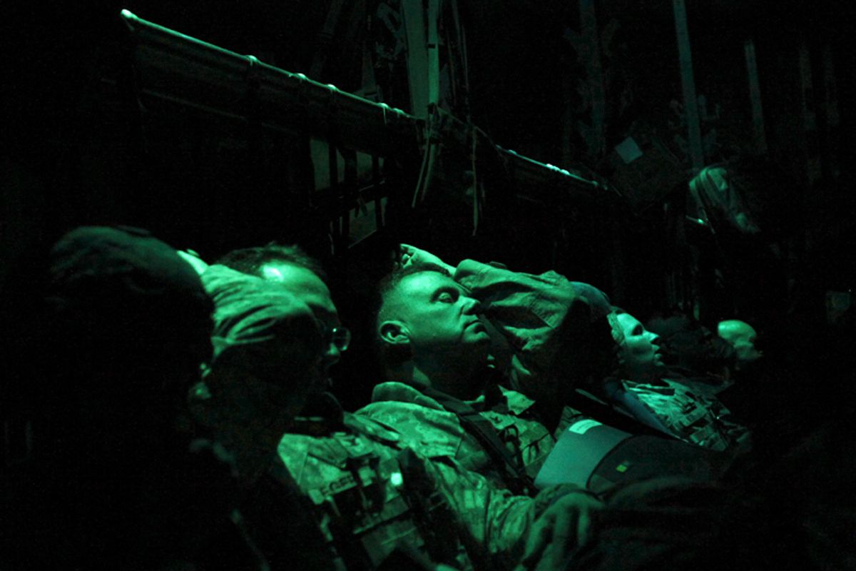Members of the U.S. military rest on board an Air Force C-130 transport plane marking the end of their presence in Iraq after departing the Baghdad Diplomatic Support Center in Baghdad December 15, 2011.  (Shannon Stapleton / Reuters)