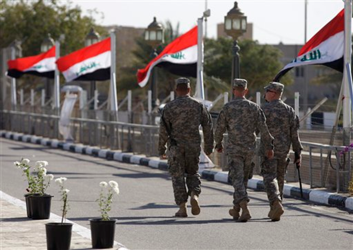 Iraqi flags wave as U.S. soldiers leave Al Faw palace at Camp Victory on Thursday, Dec. 1, 2011   (AP Photo/Khalid Mohammed)