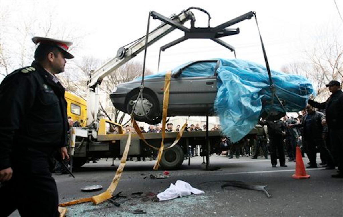 In this photo provided by the semi-official Fars News Agency, people gather around a bombed car in Tehran, Iran, Wednesday, Jan. 11, 2012   (AP Photo/Fars News Agency, Mehdi Marizad)