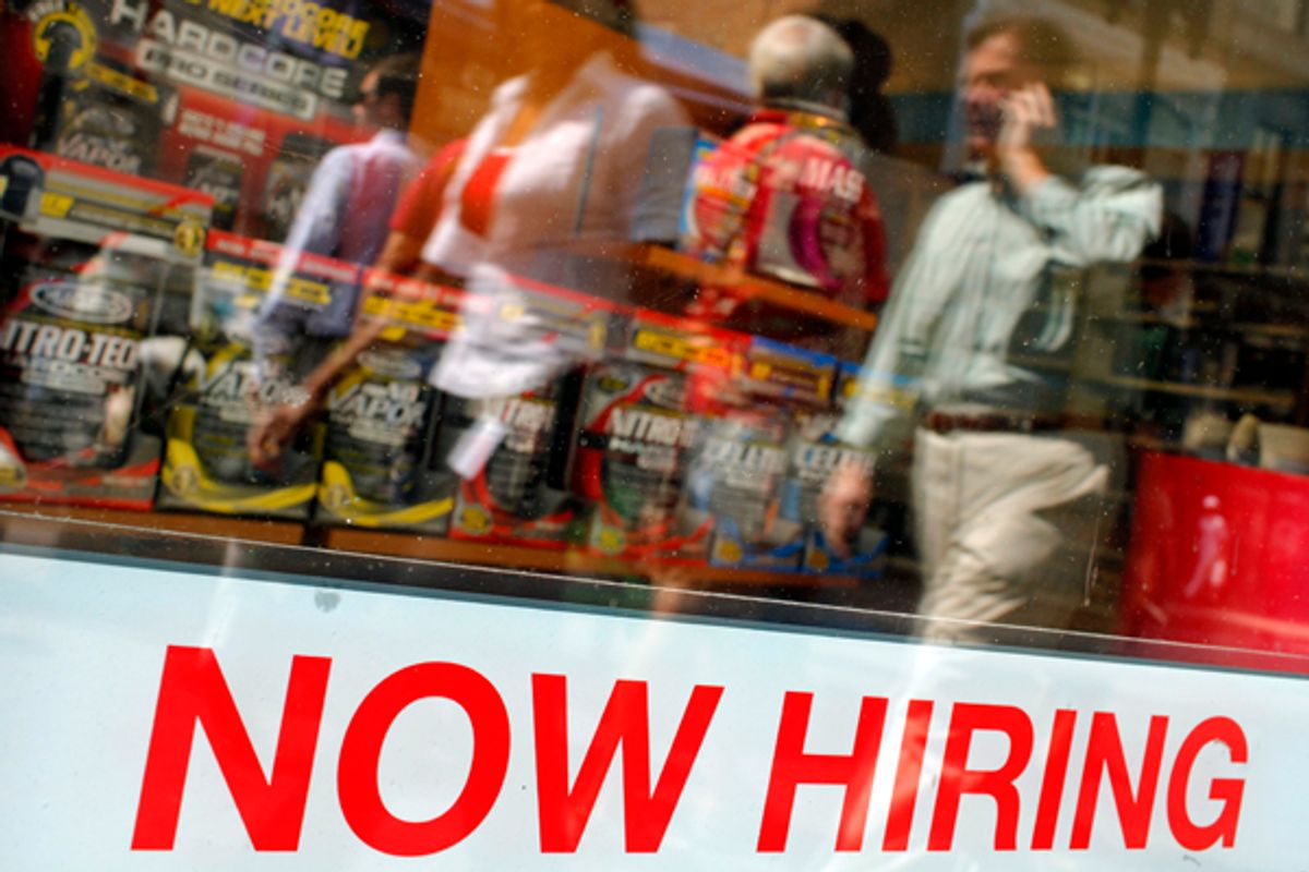 Pedestrians walk past a "Now Hiring" sign in the window of a GNC shop      (Brian Snyder / Reuters)