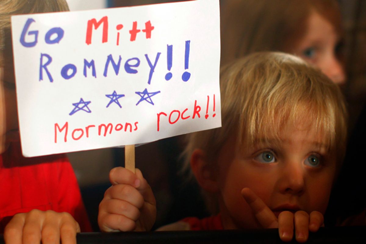 Three-year-old Dean Call holds a sign as Mitt Romney speaks during a campaign rally in Columbia, S.C., on Jan. 11, 2012.         (Brian Snyder / Reuters)