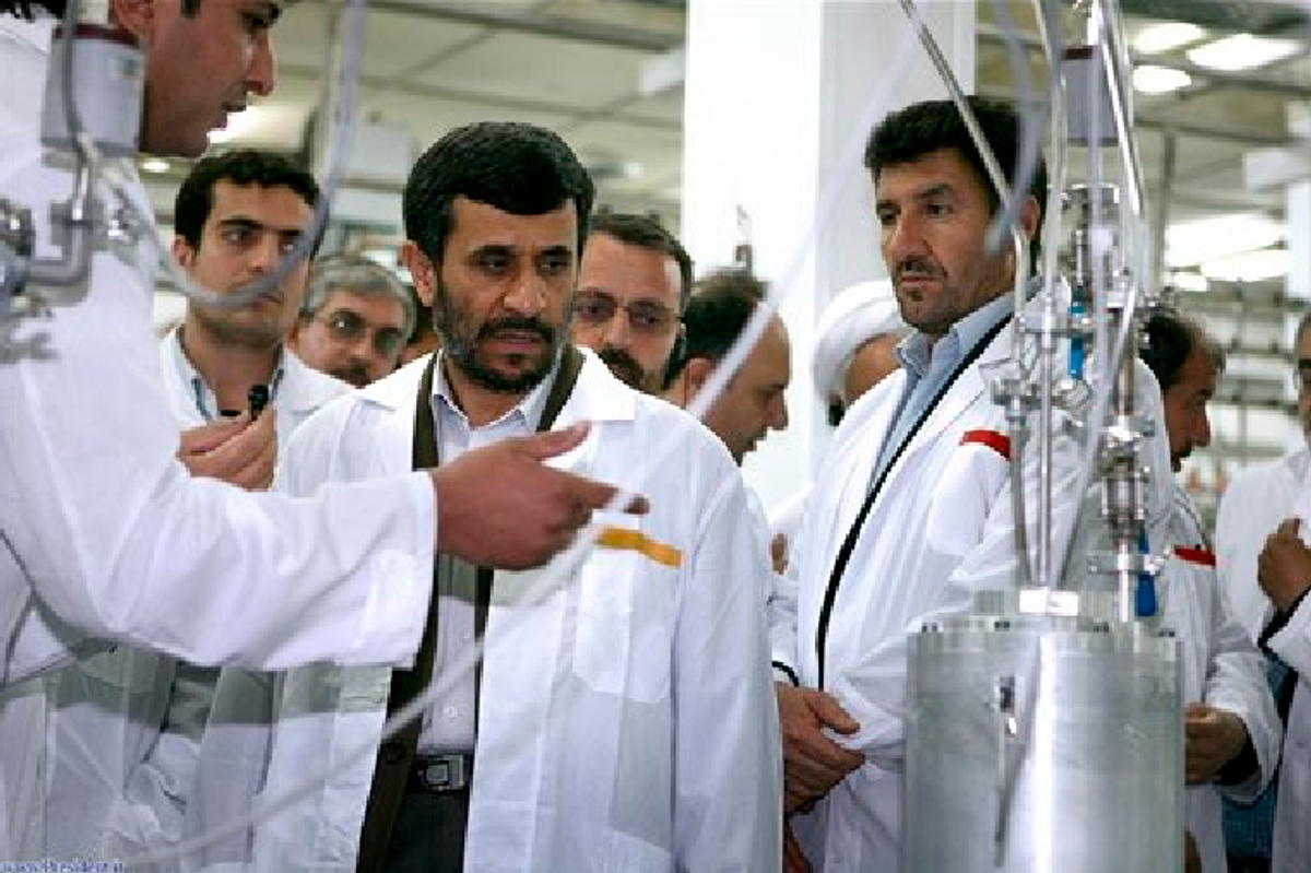  In this April 8, 2008, photo released by the Iranian President's Office, Iranian President Mahmoud Ahmadinejad, center, listens to a technician during his visit of the Natanz Uranium Enrichment Facility. (AP Photo/Iranian Presidents office, File)