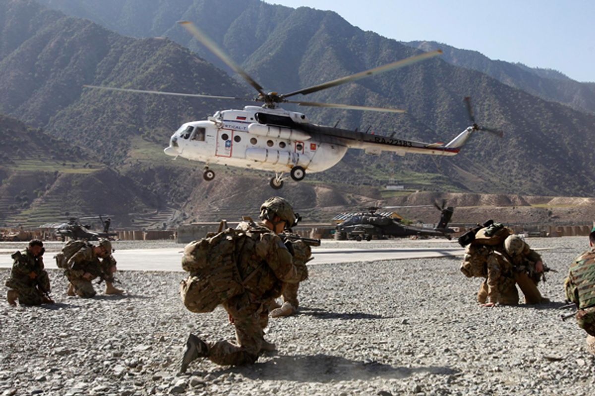 A helicopter lands near U.S. soldiers at the Forward Operating Base Bostic  in Kunar, Afghanistan     (Reuters/Erik de Castro)